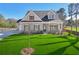 Two story house with gray siding, stone accents, and a lush lawn at 1461 Stephens View Dr, Loganville, GA 30052