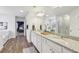 Double vanity bathroom with granite countertop and large mirror at 1451 Stephens View Dr, Loganville, GA 30052