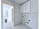 Laundry room with white cabinets and built-in shelving at 1451 Stephens View Dr, Loganville, GA 30052