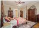 Cozy bedroom showcasing a four-poster bed, ceiling fan, area rug, and classic furnishings at 1045 N Main Nw St, Conyers, GA 30012