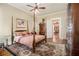 Bedroom featuring a four-poster bed, ceiling fan, hardwood floors, and elegant decor at 1045 N Main Nw St, Conyers, GA 30012