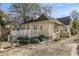 Charming home features a ramp to the deck, a white picket fence, and mature landscaping for enhanced curb appeal at 1045 N Main Nw St, Conyers, GA 30012