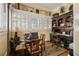 Bright home office with a dark wood desk, shelving, and charming window and traditional decor at 1045 N Main Nw St, Conyers, GA 30012