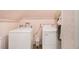 Functional laundry room with a washer, dryer, and clean, organized space at 1045 N Main Nw St, Conyers, GA 30012