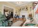 Bright living room with a white fireplace, natural light, and a decorative ceiling fan at 1045 N Main Nw St, Conyers, GA 30012