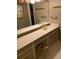 The bathroom is complete with a vanity, complete with a large mirror and floral stool at 1685 Dogwood Trl, Douglasville, GA 30134