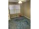 The carpeted bedroom offers cozy vibes with natural light from a window, and minimal decor at 1685 Dogwood Trl, Douglasville, GA 30134