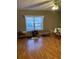 Spacious bedroom featuring hardwood floors, a large window, and neutral-toned walls at 1685 Dogwood Trl, Douglasville, GA 30134