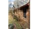 Shows brick exterior with small window and overgrown plants at 1685 Dogwood Trl, Douglasville, GA 30134