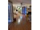 Open floor plan with wood floors features a view into the kitchen area and a traditional brick fireplace at 1685 Dogwood Trl, Douglasville, GA 30134