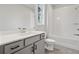 Bathroom featuring a quartz countertop and a white tiled shower over tub at 3816 Havenrock Drive, Marietta, GA 30066