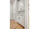 Hallway with white cabinets, black hardware, and hardwood floors at 3816 Havenrock Drive, Marietta, GA 30066