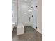 Close up of glass enclosed shower with bench seating and marble tiled walls at 3816 Havenrock Drive, Marietta, GA 30066