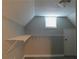 Attic space with a built-in shelf and a window, providing storage or creative potential at 99 Libby Ln, Jonesboro, GA 30238