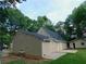 Home exterior featuring a well-maintained yard, a detached garage, and a small concrete patio at 99 Libby Ln, Jonesboro, GA 30238