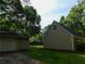 View of a home's side exterior featuring a detached garage and a well-maintained, green lawn at 99 Libby Ln, Jonesboro, GA 30238