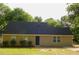 Charming single-story home featuring a dark roof, neutral siding, and manicured front yard landscaping at 99 Libby Ln, Jonesboro, GA 30238