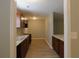 View of the eat-in kitchen, which features a stainless steel sink, wooden cabinetry, and grey countertops at 99 Libby Ln, Jonesboro, GA 30238