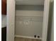 View of the laundry room with white shelving and light grey walls at 99 Libby Ln, Jonesboro, GA 30238