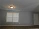 Sunlit living room boasting wood-look flooring, neutral walls, and a large window for natural light at 99 Libby Ln, Jonesboro, GA 30238