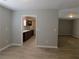 Bright living room with wood-look flooring, neutral paint, and an open doorway to the kitchen at 99 Libby Ln, Jonesboro, GA 30238