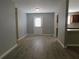 Open-concept living room featuring wood-look floors and views into the kitchen area at 99 Libby Ln, Jonesboro, GA 30238
