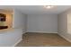 Open living space with wood-look flooring and views into the kitchen and breakfast bar area at 99 Libby Ln, Jonesboro, GA 30238