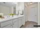 Well-lit bathroom with double sinks, tile flooring, and neutral color scheme at 3298 Sheffield Cir, Decatur, GA 30032