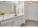 Bright bathroom featuring a double sink vanity, white cabinetry, and tile flooring at 3298 Sheffield Cir, Decatur, GA 30032