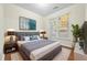 Stylish bedroom with a large bed, neutral tones, and natural light from the window at 3298 Sheffield Cir, Decatur, GA 30032