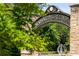 Entrance to Abernathy Greenway with stone archway and sign amidst lush greenery, welcoming visitors at 318 Sandy Springs Cir # 310, Sandy Springs, GA 30328