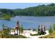 Scenic outdoor space featuring a stone fireplace, pergola, and views of the serene lake, ideal for gatherings at 318 Sandy Springs Cir # 310, Sandy Springs, GA 30328