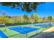 Well-maintained tennis courts offer an active lifestyle amidst lush greenery and clear skies, perfect for enthusiasts at 318 Sandy Springs Cir # 310, Sandy Springs, GA 30328