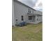 Home's back features a patio, two AC units and grassy yard at 5418 Flat Rock Pt, Stonecrest, GA 30038