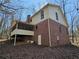 View of the back exterior with a screened porch, brick siding and white trim at 25 Ridgeview Dr, Jonesboro, GA 30236