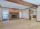 Cozy living room featuring a brick fireplace, neutral carpet, and large windows at 25 Ridgeview Dr, Jonesboro, GA 30236