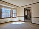 Bright living room with large windows, neutral walls, carpet, and a view of the outdoors at 25 Ridgeview Dr, Jonesboro, GA 30236