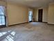 A bright living room featuring large windows and neutral carpet at 25 Ridgeview Dr, Jonesboro, GA 30236