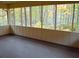 Enclosed sunroom offering wooded views through the screen windows at 25 Ridgeview Dr, Jonesboro, GA 30236