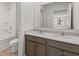 Bathroom featuring dual sinks with granite counters and a large mirror at 67 Hampton Ter, Dallas, GA 30157