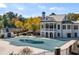 View of the covered community pool and beautiful white clubhouse with a patio and a covered deck at 67 Hampton Ter, Dallas, GA 30157