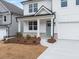 Close-up of the home's front porch featuring white columns, brick accents, and a light blue front door at 79 Hampton Ter, Dallas, GA 30157