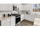 Close-up of kitchen with white cabinets, granite counters, subway tile backsplash, and stainless steel appliances at 79 Hampton Ter, Dallas, GA 30157