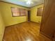 Simple bedroom with hardwood floors, built-in shelves, and ample closet space at 1868 Fort Valley Sw Dr, Atlanta, GA 30311