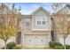 Charming townhome with brick and siding exterior, attached two-car garage and manicured landscaping at 4429 Newfangle Rd, Stone Mountain, GA 30083