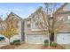 Attractive townhome featuring brick and siding, attached two-car garage, and appealing landscaping at 4429 Newfangle Rd, Stone Mountain, GA 30083