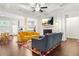 Open-concept living room featuring coffered ceiling, fireplace, and hardwood floors at 4429 Newfangle Rd, Stone Mountain, GA 30083