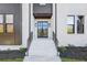 Modern home exterior with white brick, dark accents, and a stylish front door at 3225 Greenfield Dr, Marietta, GA 30068