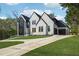 Stunning two-story home featuring a modern design, black window frames, and an attached two-car garage at 3225 Greenfield Dr, Marietta, GA 30068