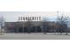 View of Stonecrest commercial building, set back from a spacious parking area with decorative trees at 5985 Spring Way, Stonecrest, GA 30038